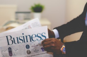 Man reading Business section of the newspaper 