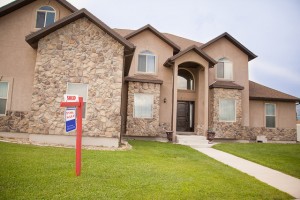 for sale sign in front of house