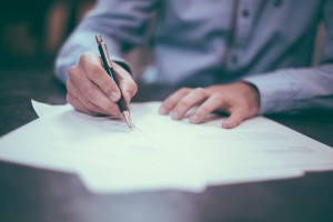 businessman signing documents