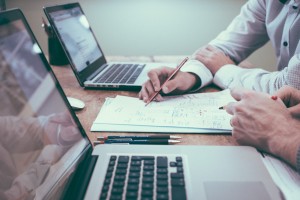 two businessmen writing notes